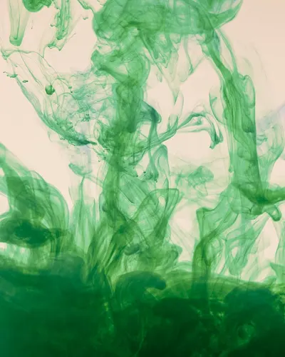 Captivating abstract image of green ink swirling elegantly in water motion. 4k abstract wallpaper