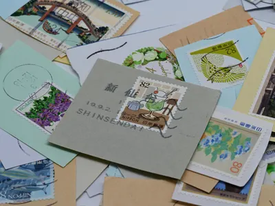 A diverse collection of colorful Japanese postage stamps featuring various desig 4k anime wallpaper