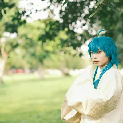 A person in elaborate cosplay with blue hair, standing in a sunlit park. 4k anime wallpaper