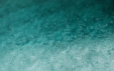 Serene teal water surface with ripples and raindrops, perfect for backgrounds. 4k anime wallpaper