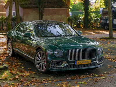 A luxurious Bentley parked on a leafy street, showcasing autumn's charm and eleg 4k cars wallpaper