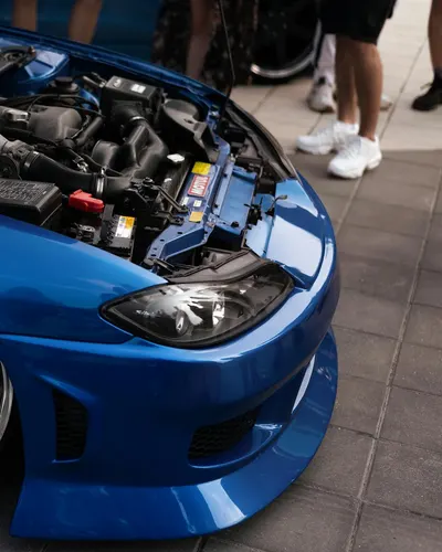 Detailed view of a blue sports car with its hood open, showcasing the engine. 4k cars wallpaper