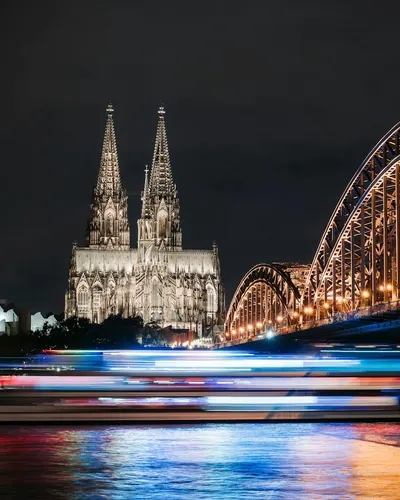 Dramatic night scene of Cologne Cathedral and Hohenzollern Bridge with illuminat 4k city wallpaper