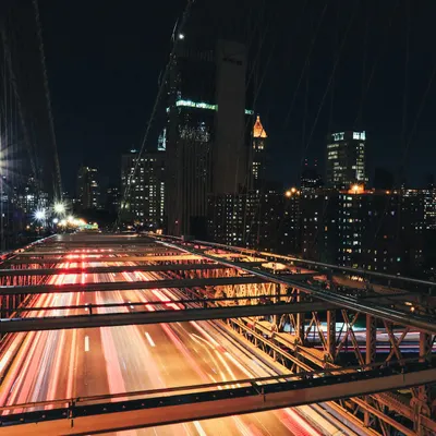 Long exposure shot capturing traffic on Brooklyn Bridge, NYC, at night with illu 4k city wallpaper