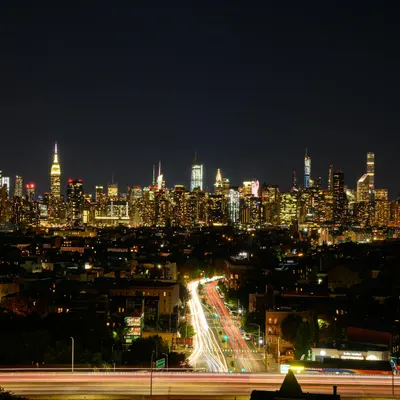 Stunning nighttime view of New York City skyline with vibrant lights and long ex 4k city wallpaper
