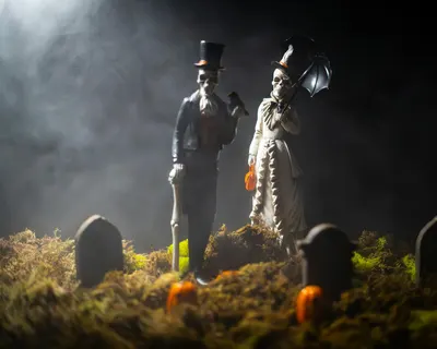 Mysterious skeleton figures in Victorian attire amidst gravestones, perfect for  4k dark wallpaper