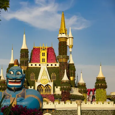 Enchanting garden castle with vibrant flowers and a whimsical blue genie statue  4k fantasy wallpaper