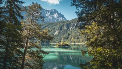 Breathtaking view of Eibsee Lake reflecting the Bavarian Alps surrounded by lush 4k lake wallpaper