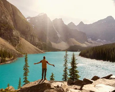 Capture the breathtaking view of Moraine Lake with a solo adventurer under the s 4k lake wallpaper