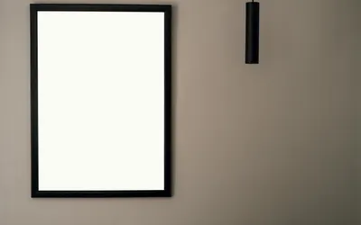 A minimalist picture frame on a neutral wall with hanging light and ample copy s 4k minimal wallpaper