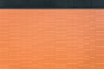 Detailed view of an orange brick wall with horizontal lines and geometric patter 4k minimal wallpaper
