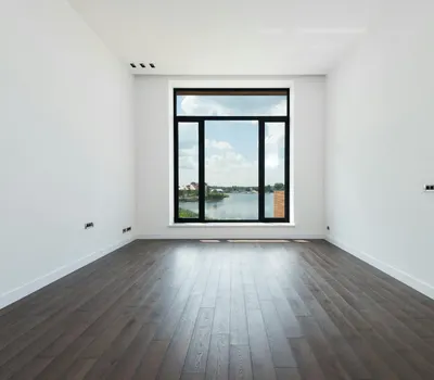 Interior of modern spacious light room with wooden laminate floor white walls an 4k minimal wallpaper