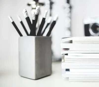 Pencils notebooks stack 4k minimal wallpaper
