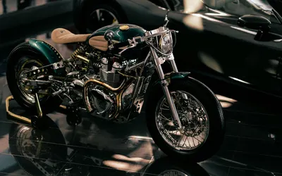 Classic motorcycle displayed in a dimly lit showroom, highlighting its vintage d 4k motorcycle wallpaper
