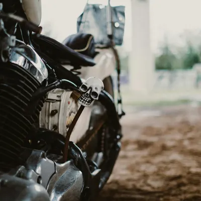 Detailed close-up of a classic motorcycle with a skull-themed decorative element 4k motorcycle wallpaper