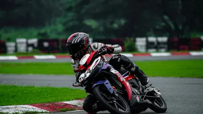 Motorcycle racer in protective gear leans during a turn on a race track. 4k motorcycle wallpaper