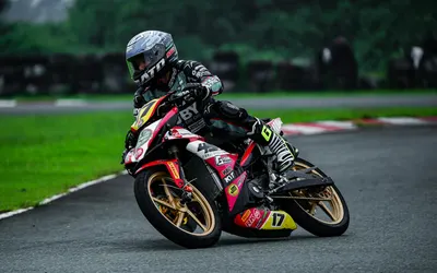 Professional motorcycle racer on a track in Tarlac City, showing dynamic speed a 4k motorcycle wallpaper