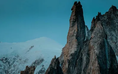 Breathtaking view of snow-capped peaks in Haute-Savoie, France, under a clear bl 4k mountain wallpaper
