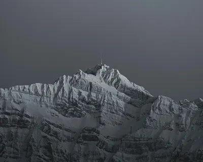Captivating view of a snow-covered mountain peak in Switzerland's scenic Alps at 4k mountain wallpaper