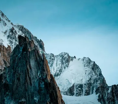 Stunning snow-capped mountain peaks under a clear blue sky. Perfect for nature p 4k mountain wallpaper