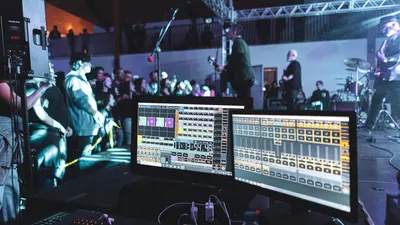 Live concert scene with sound engineering setup and band on stage. 4k music wallpaper