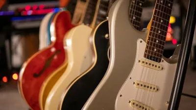 Row of electric guitars with a focus on elegant design and strings. 4k music wallpaper