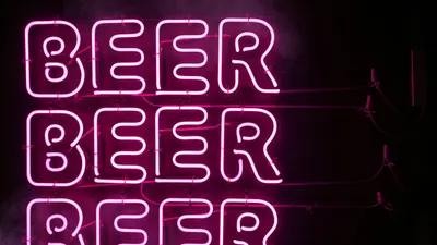 Bright pink neon sign displaying the word 'BEER' in Tokyo, Japan, at night. 4k neon wallpaper