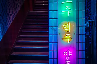 Colorful neon sign on a staircase in Seoul reflects nightlife and vibrant atmosp 4k neon wallpaper