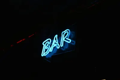 Glowing blue neon bar sign against a dark background, perfect for nightlife them 4k neon wallpaper